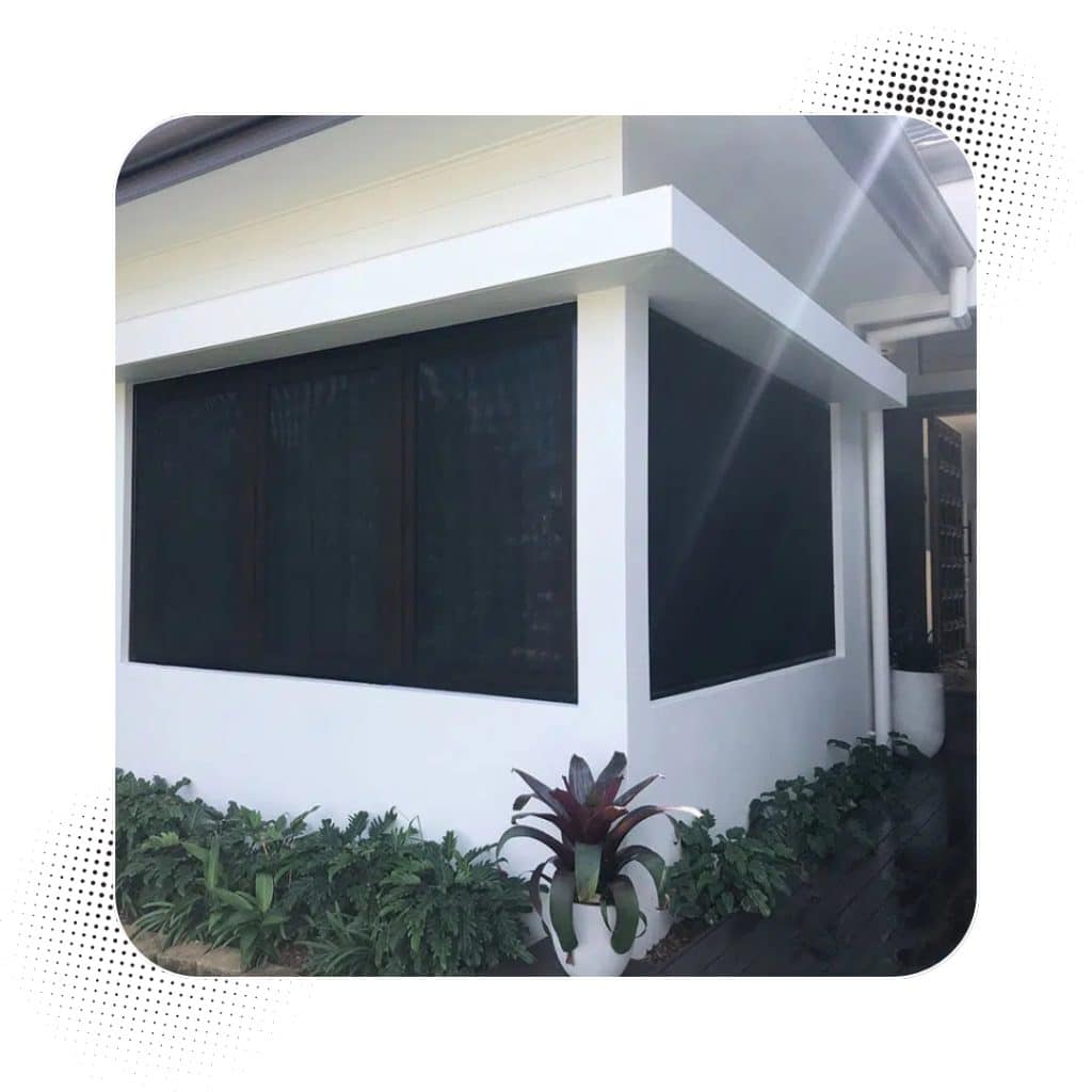 Modern white home with black-framed security screen windows installed for privacy and protection.