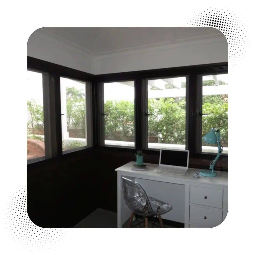 Home office with security screen windows providing clear outside visibility and enhanced indoor safety.